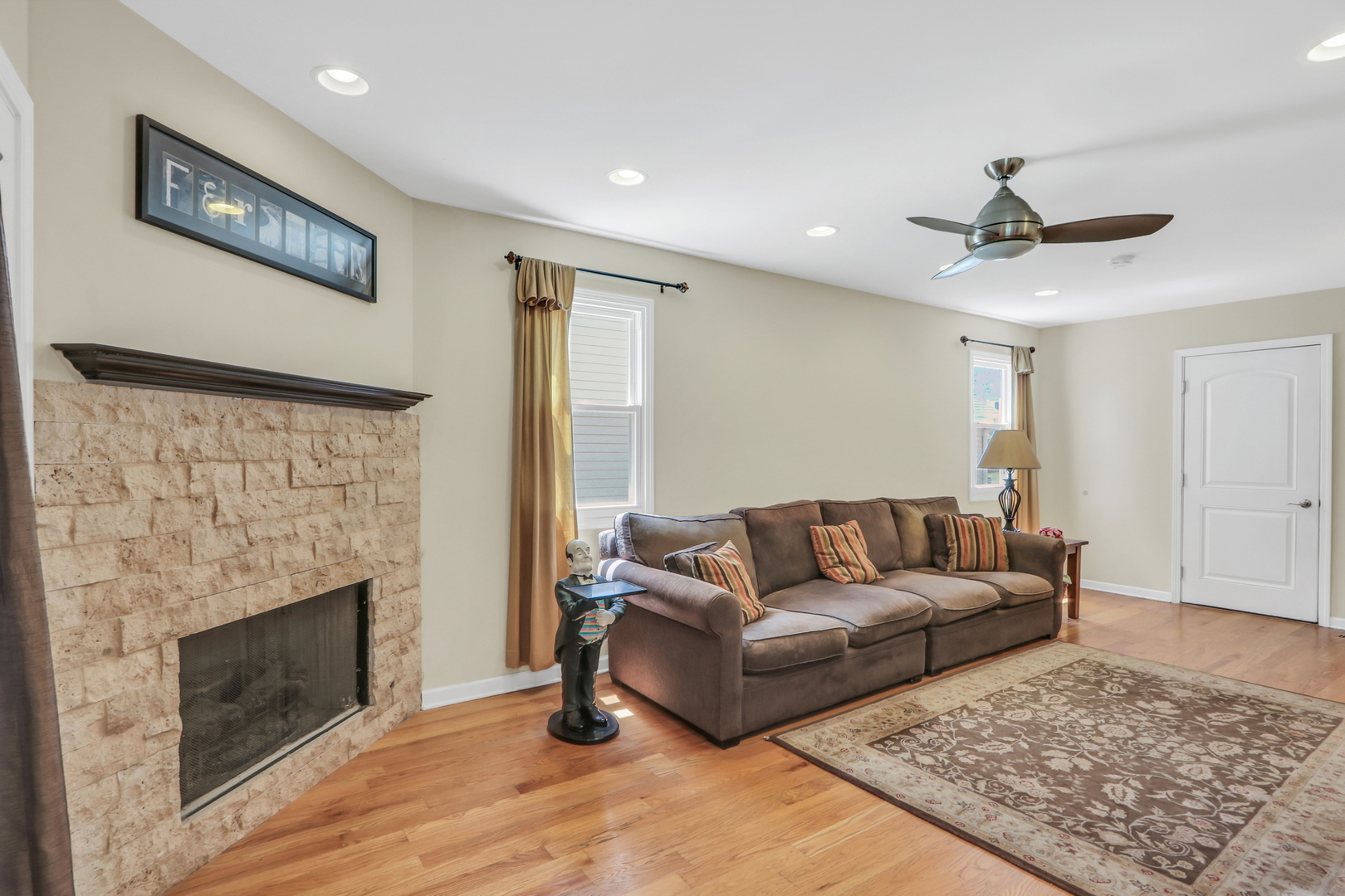 1215 Devonshire Road Buffalo Grove, IL 60089 - Photo 15 of 36 a living room with furniture and a fireplace
