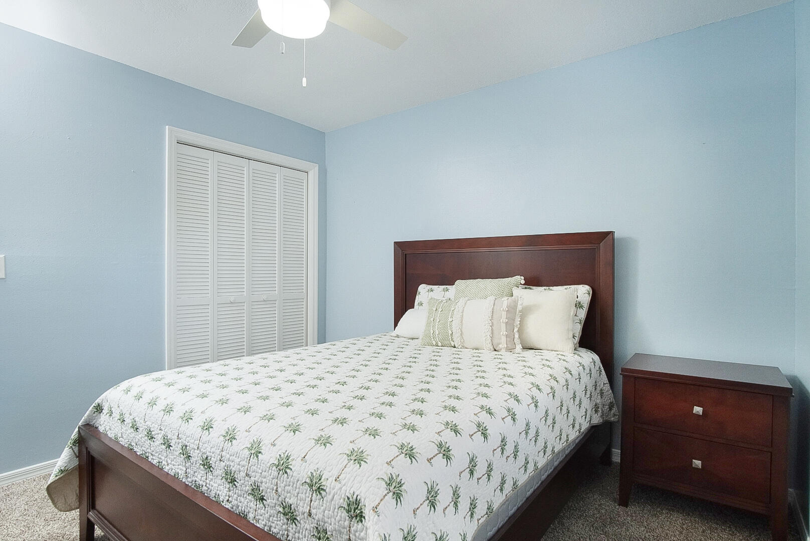 6041 Southeast Landing Way Stuart, FL 34997 - Photo 23 of 30 a bedroom with a bed and a lamp