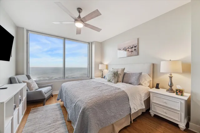 a bathroom with a granite countertop double vanity sink a mirror and a shower