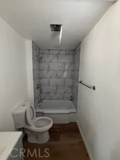 a bathroom with a toilet a sink and bathtub