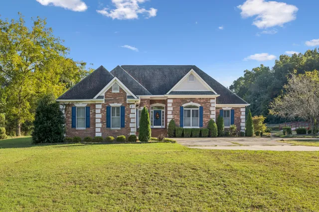 a front view of house with yard and green space