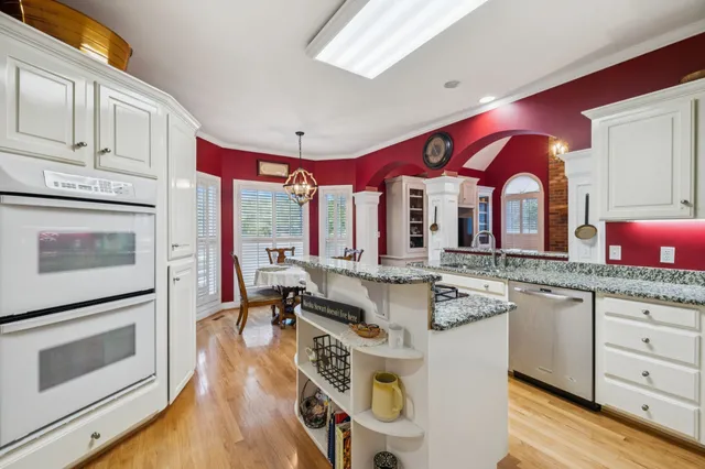 a bathroom with a toilet sink vanity and mirror