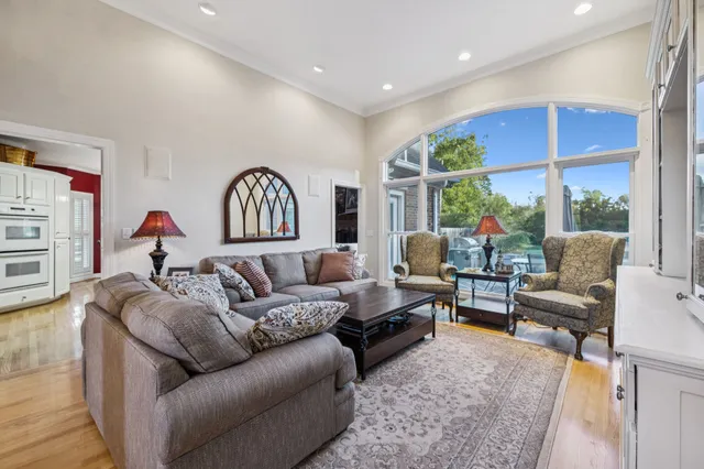 a living room with furniture large window and a fireplace