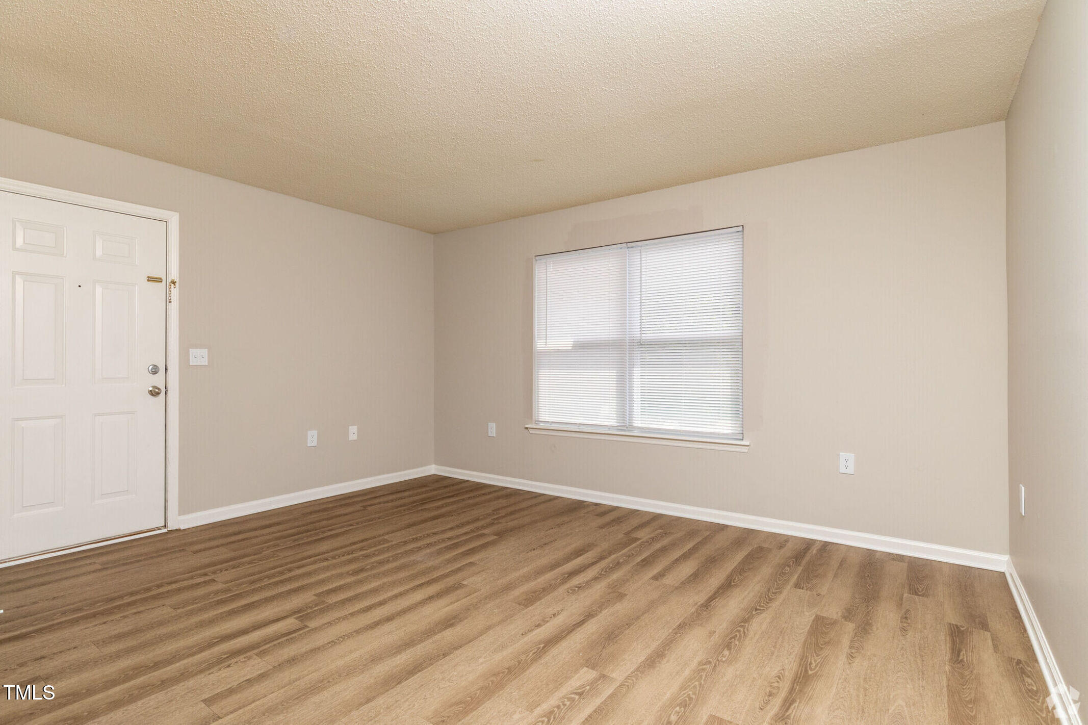 115 Holiday Park Road, Unit 3BED Hillsborough, NC 27278 - Photo 3 of 16 an empty room with wooden floor and windows