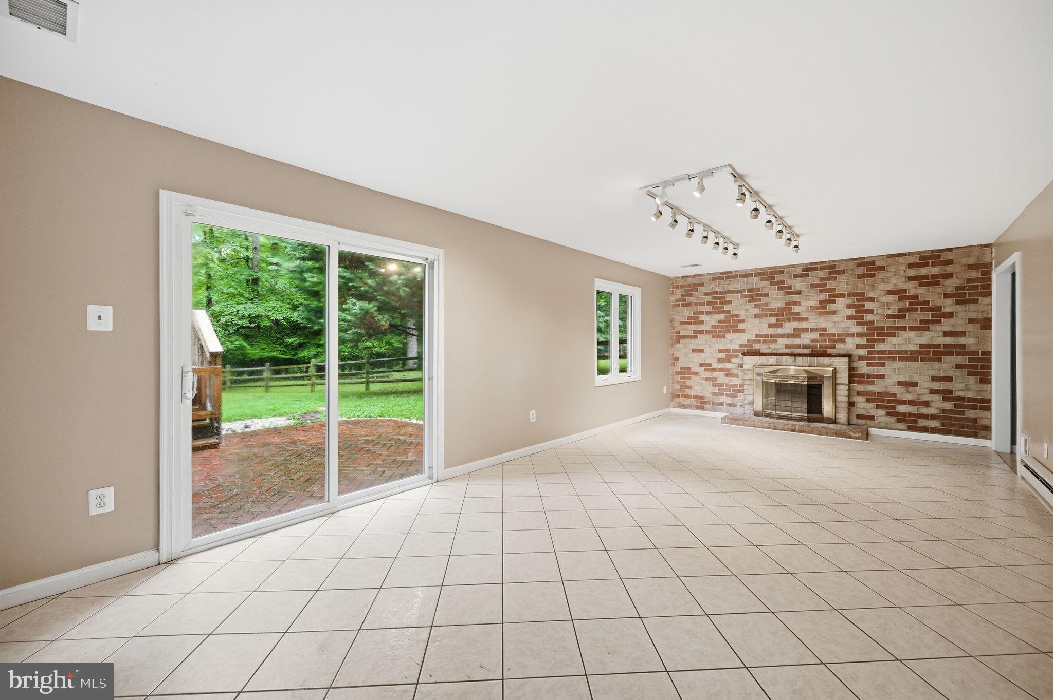 2506 Pinoak Lane Reston, VA 20191 - Photo 22 of 33 a view of an empty room with a fireplace and a window