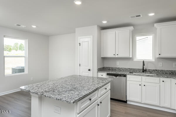 64 Rider Street Broadway, NC 27505 - Photo 3 of 11 a kitchen with granite countertop cabinets sink and window