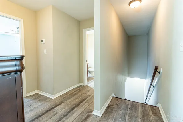 a bathroom with a granite countertop sink a toilet and a mirror