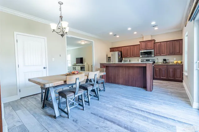 a kitchen with a table and chairs in it