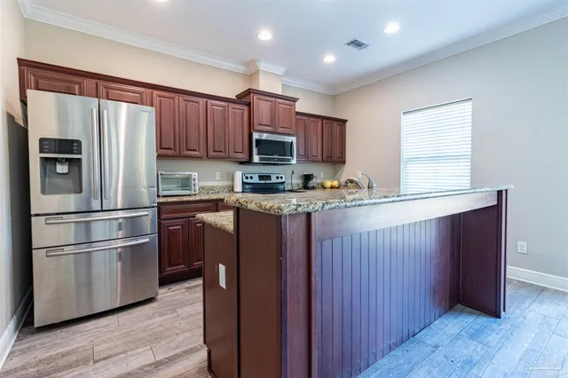 a kitchen with sink cabinets and wooden floor