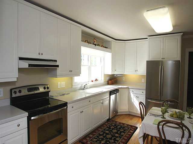 1031 Harvey Street Raleigh, NC 27608 - Photo 5 of 12 a kitchen with stainless steel appliances a stove sink and refrigerator