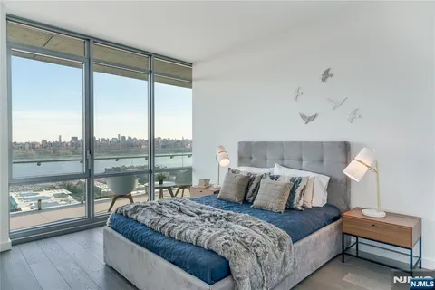 a bedroom with a large bed and a large window