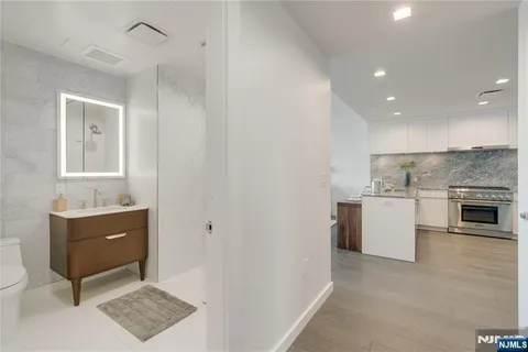 a view of kitchen with granite countertop cabinets and white appliances