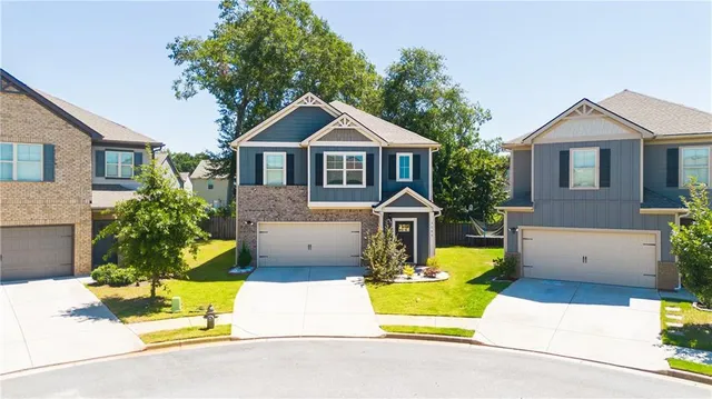 a front view of a house with a yard and garage