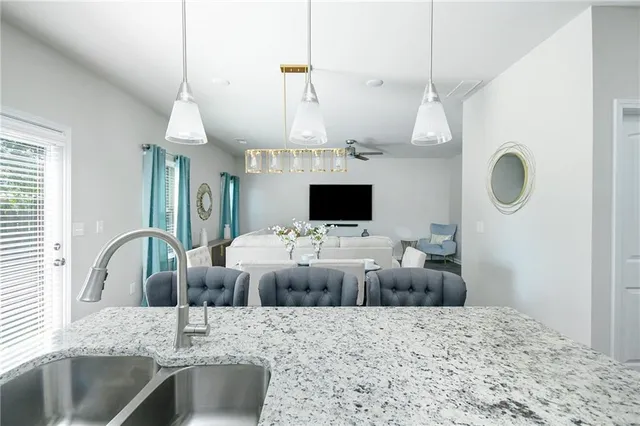 a kitchen with stainless steel appliances granite countertop a stove microwave and refrigerator