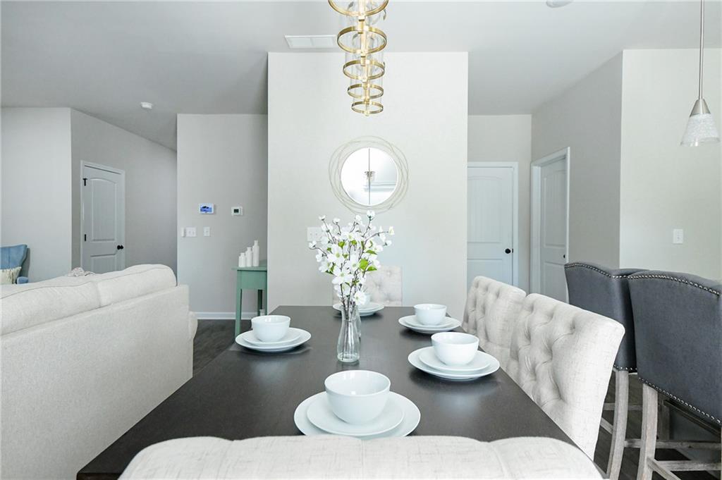 2288 Elsie Way Hampton, GA 30228 - Photo 16 of 45 a living room with furniture and a table