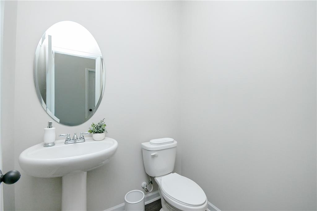 2288 Elsie Way Hampton, GA 30228 - Photo 18 of 45 a bathroom with a toilet sink and mirror