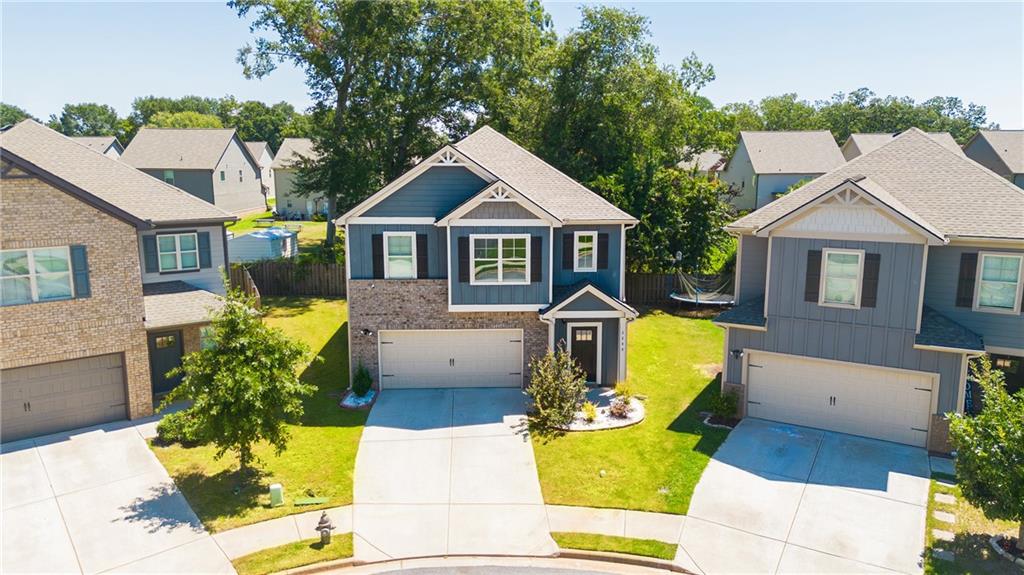 2288 Elsie Way Hampton, GA 30228 - Photo 2 of 45 a front view of a house with yard and patio
