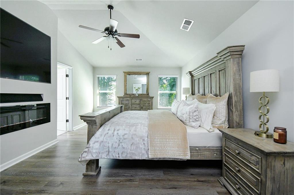 2288 Elsie Way Hampton, GA 30228 - Photo 21 of 45 a bedroom with a bed and a flat screen tv