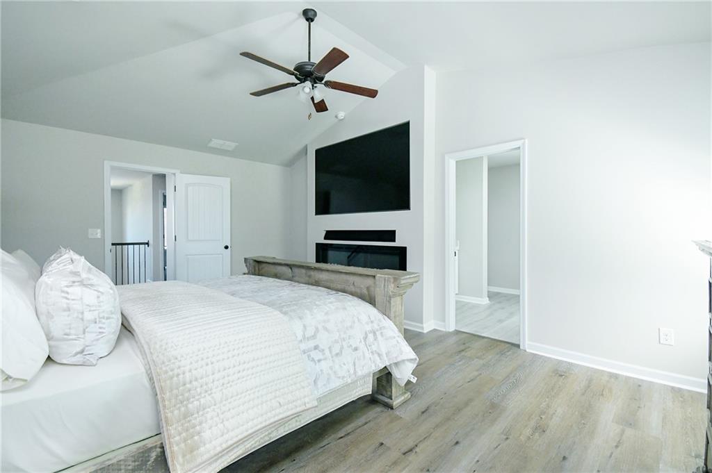 2288 Elsie Way Hampton, GA 30228 - Photo 23 of 45 a bedroom with a bed and a flat tv screen on dresser