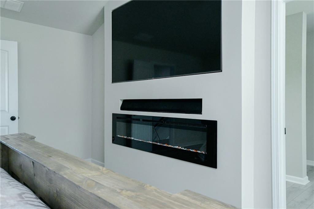 2288 Elsie Way Hampton, GA 30228 - Photo 24 of 45 a living room with a fireplace and a flat screen tv