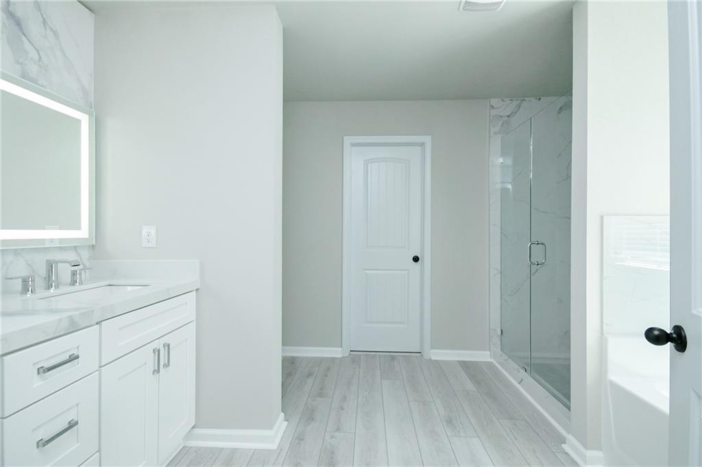 2288 Elsie Way Hampton, GA 30228 - Photo 25 of 45 a bathroom with a sink and a mirror