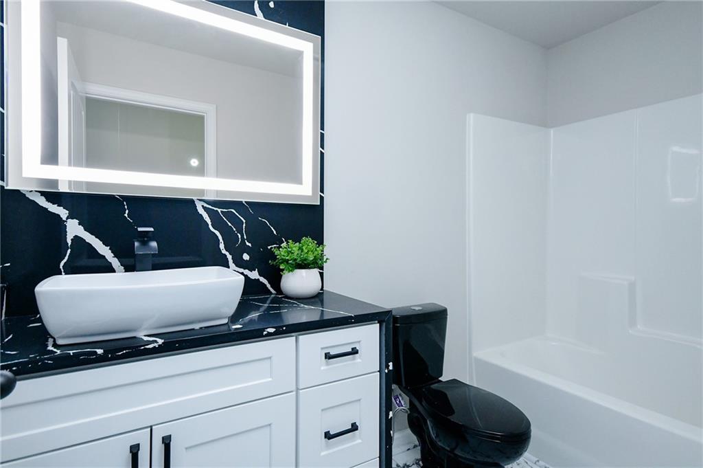 2288 Elsie Way Hampton, GA 30228 - Photo 31 of 45 a living room with furniture and a potted plant