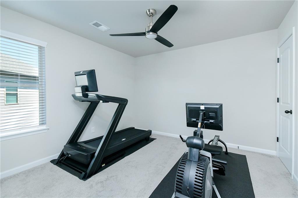 2288 Elsie Way Hampton, GA 30228 - Photo 32 of 45 a living room with furniture and a window