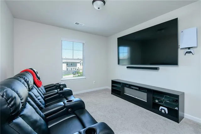 a view of a workspace with furniture and a flat screen tv