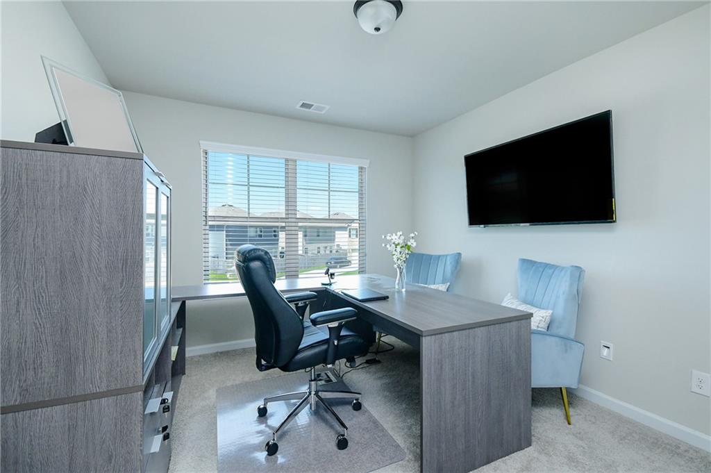 2288 Elsie Way Hampton, GA 30228 - Photo 34 of 45 a view of a workspace with furniture and a flat screen tv