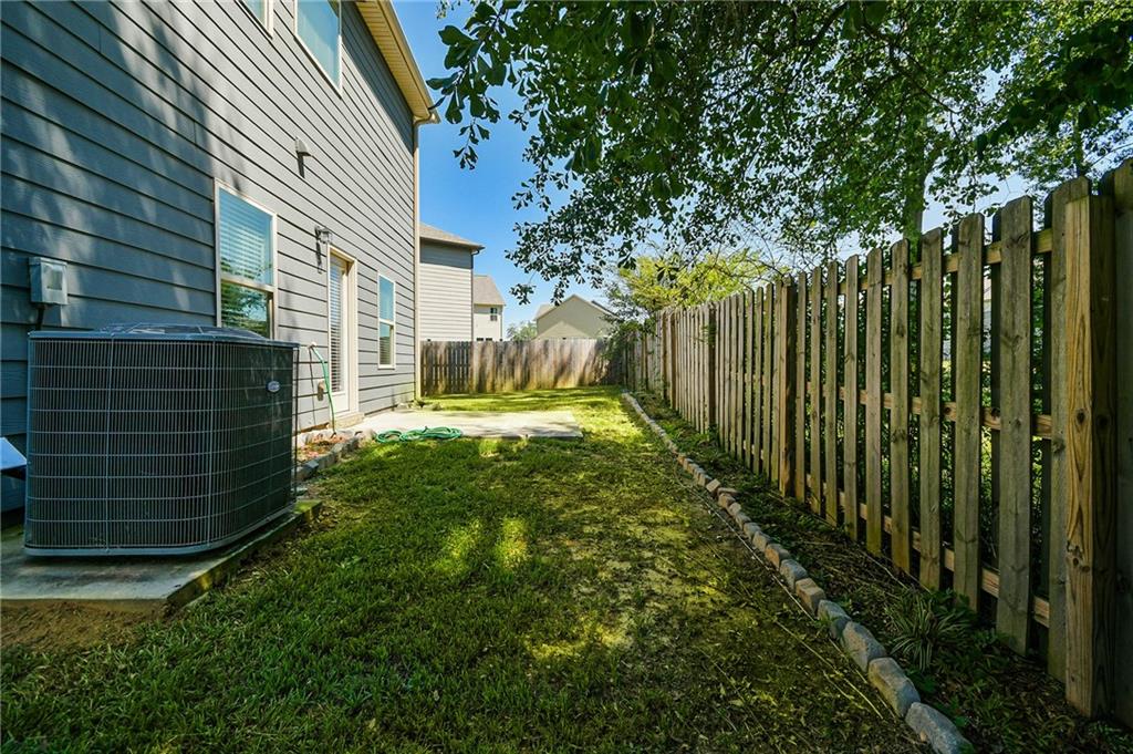 2288 Elsie Way Hampton, GA 30228 - Photo 38 of 45 a view of a yard with plants and a large tree