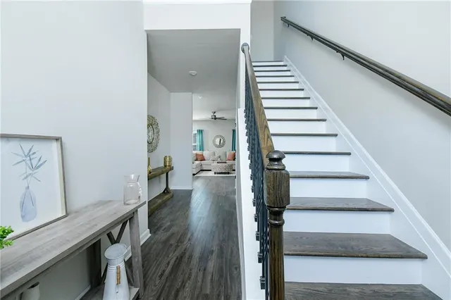 a view of entryway and hall with wooden floor