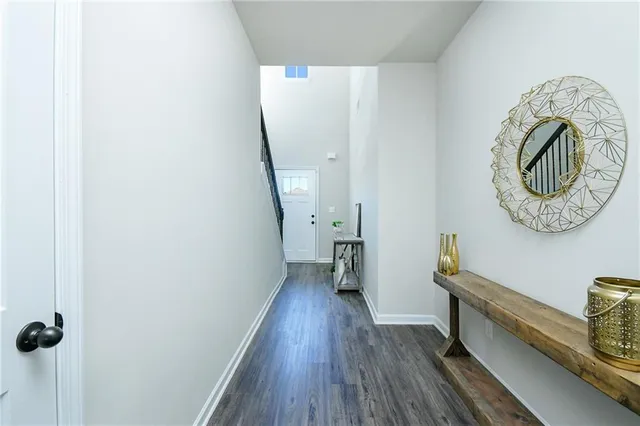 a living room with furniture flat screen tv and wooden floor