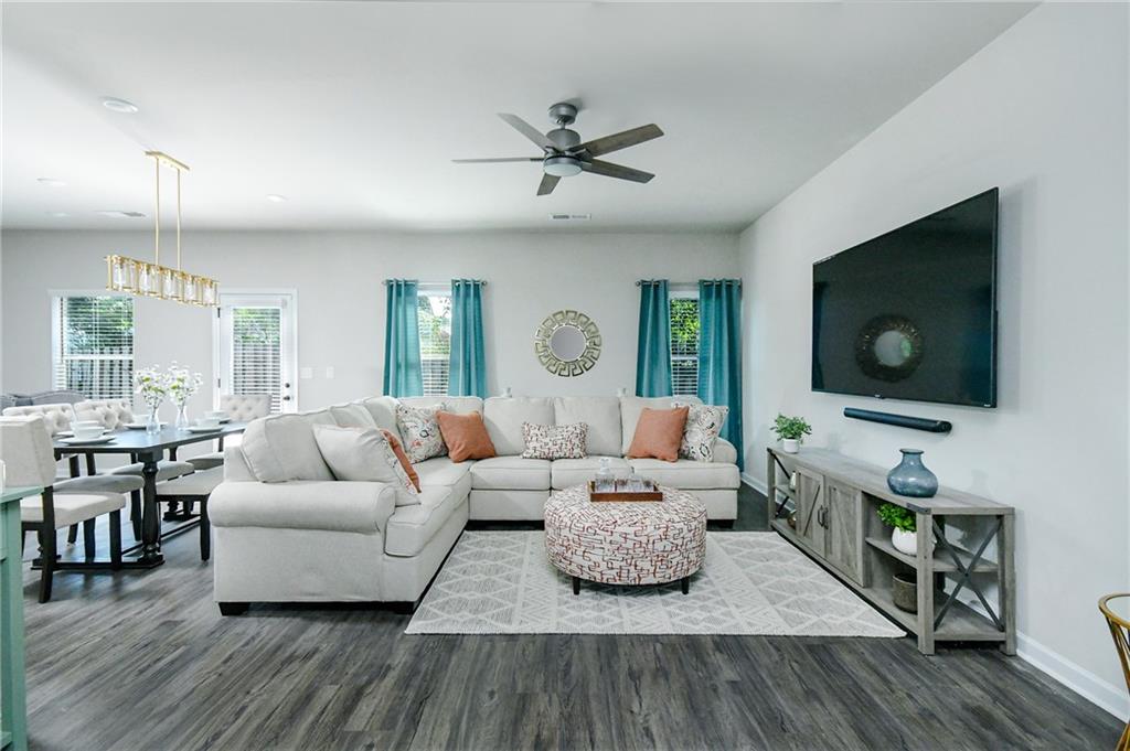 2288 Elsie Way Hampton, GA 30228 - Photo 7 of 45 a living room with furniture flat screen tv and wooden floor