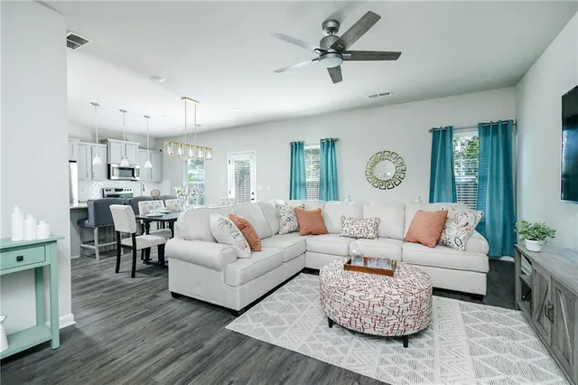 a living room with furniture and a chandelier