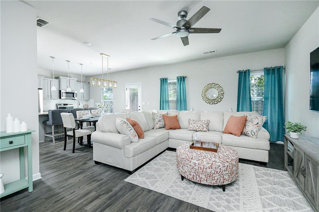 2288 Elsie Way Hampton, GA 30228 - Photo 8 of 45 a living room with furniture kitchen view and a large window