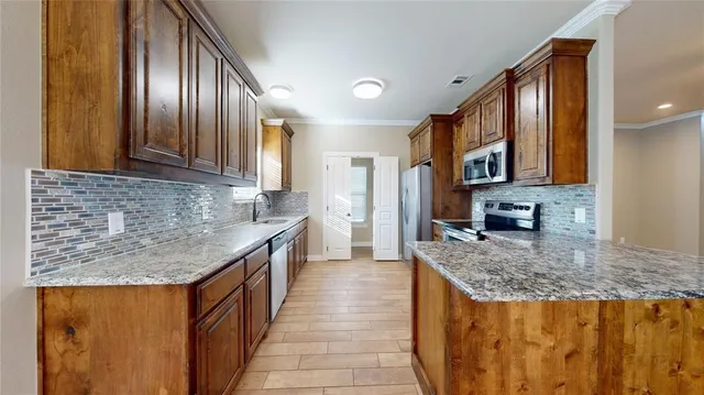 a kitchen with stainless steel appliances granite countertop lots of counter top space