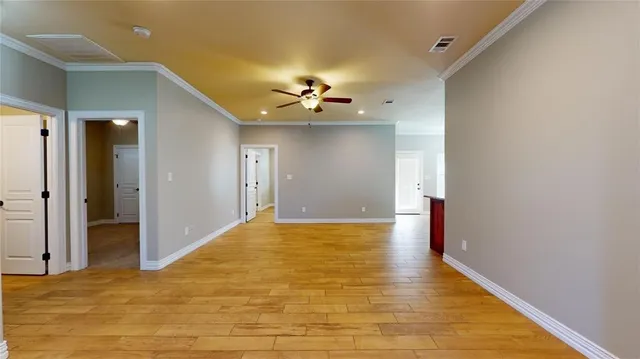 a view of a livingroom with a ceiling fan window and hardwood floor