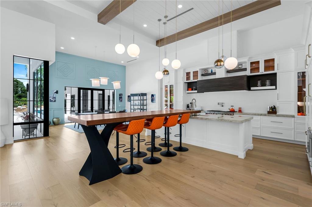 6677 Hunters Road Naples, FL 34109 - Photo 14 of 50 a large white kitchen with lots of counter space a sink and appliances