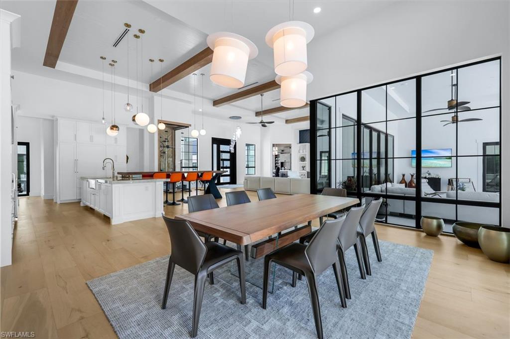 6677 Hunters Road Naples, FL 34109 - Photo 17 of 50 a view of a dining room with furniture window and wooden floor
