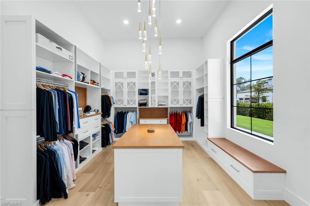 6677 Hunters Road Naples, FL 34109 - Photo 21 of 50 a very nice looking room with a large window and flat screen tv