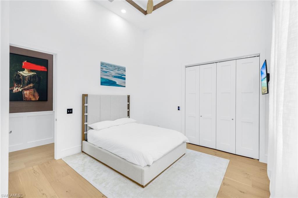 6677 Hunters Road Naples, FL 34109 - Photo 24 of 50 a bedroom with a bed and a painting on the wall