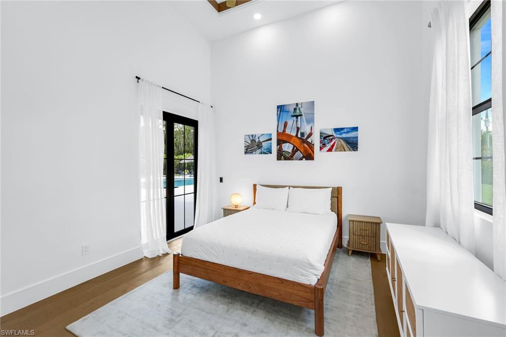 6677 Hunters Road Naples, FL 34109 - Photo 26 of 50 a bedroom with a bed and a window
