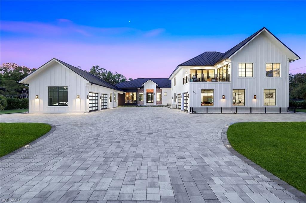 6677 Hunters Road Naples, FL 34109 - Photo 3 of 50 a front view of a house with garden