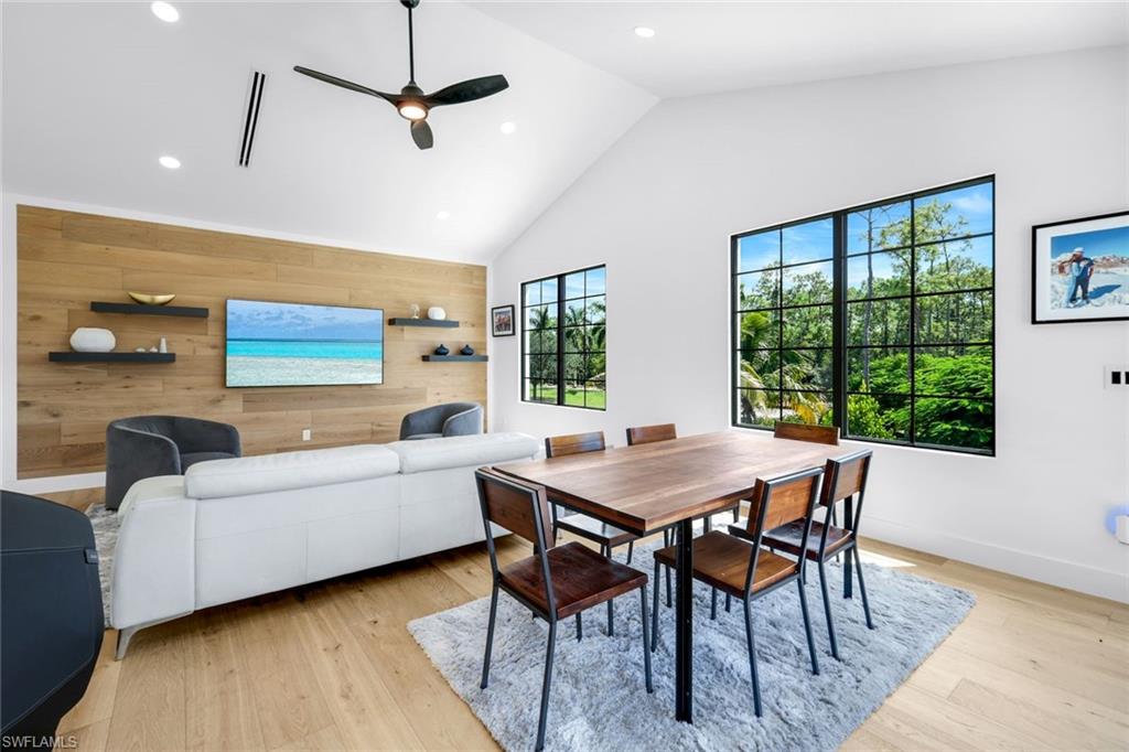 6677 Hunters Road Naples, FL 34109 - Photo 35 of 50 a view of a dining room with furniture window and wooden floor