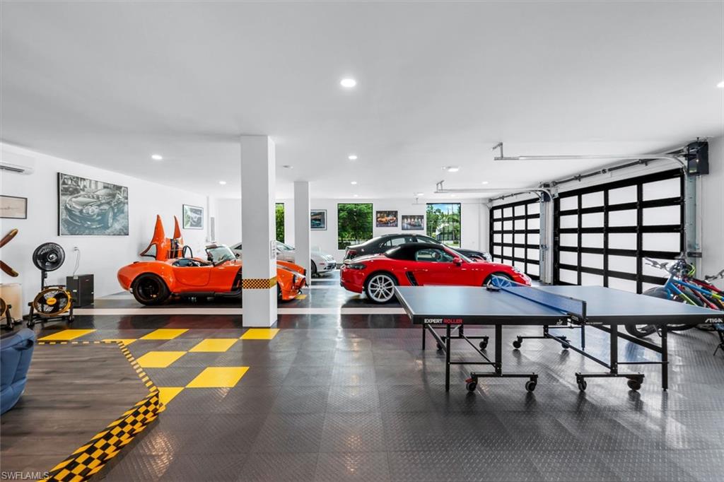 6677 Hunters Road Naples, FL 34109 - Photo 39 of 50 a room with furniture and a chandelier