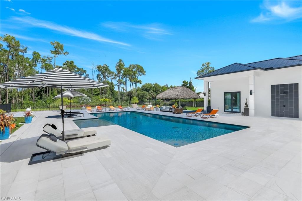 6677 Hunters Road Naples, FL 34109 - Photo 41 of 50 a view of a swimming pool with a patio