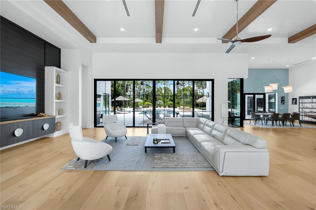 6677 Hunters Road Naples, FL 34109 - Photo 7 of 50 a living room with furniture and a flat screen tv