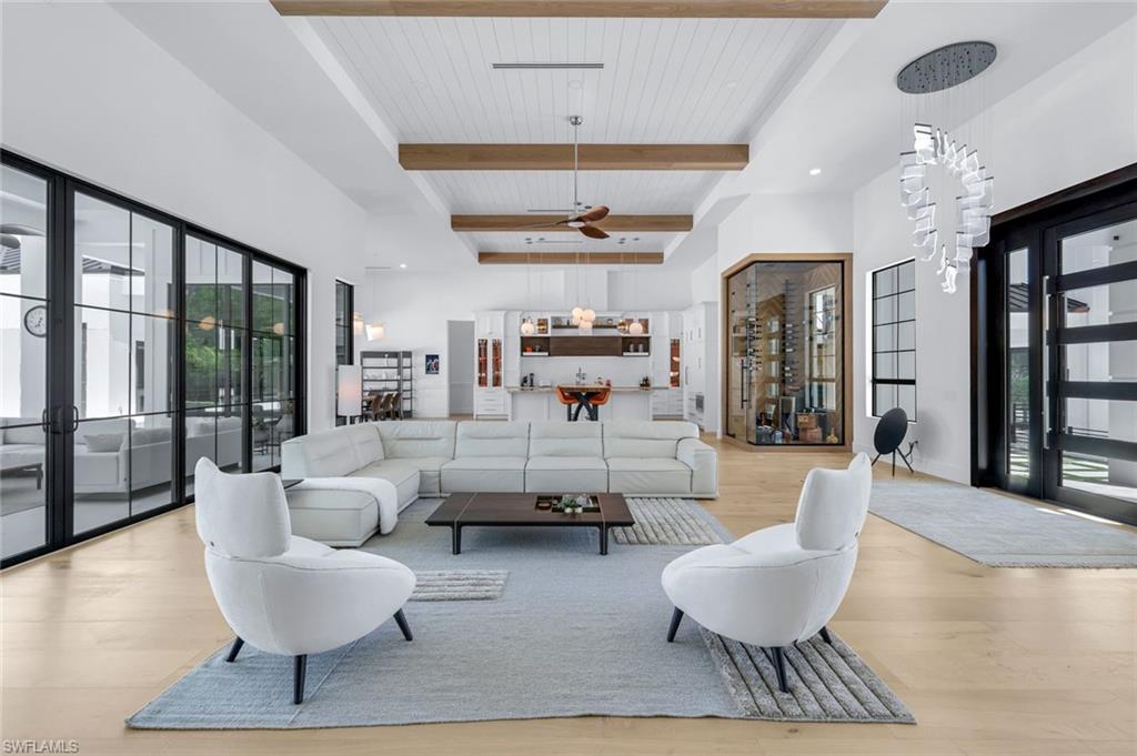 6677 Hunters Road Naples, FL 34109 - Photo 9 of 50 a living room with furniture and a chandelier