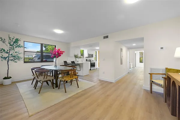 a view of a dining room with furniture and wooden floor