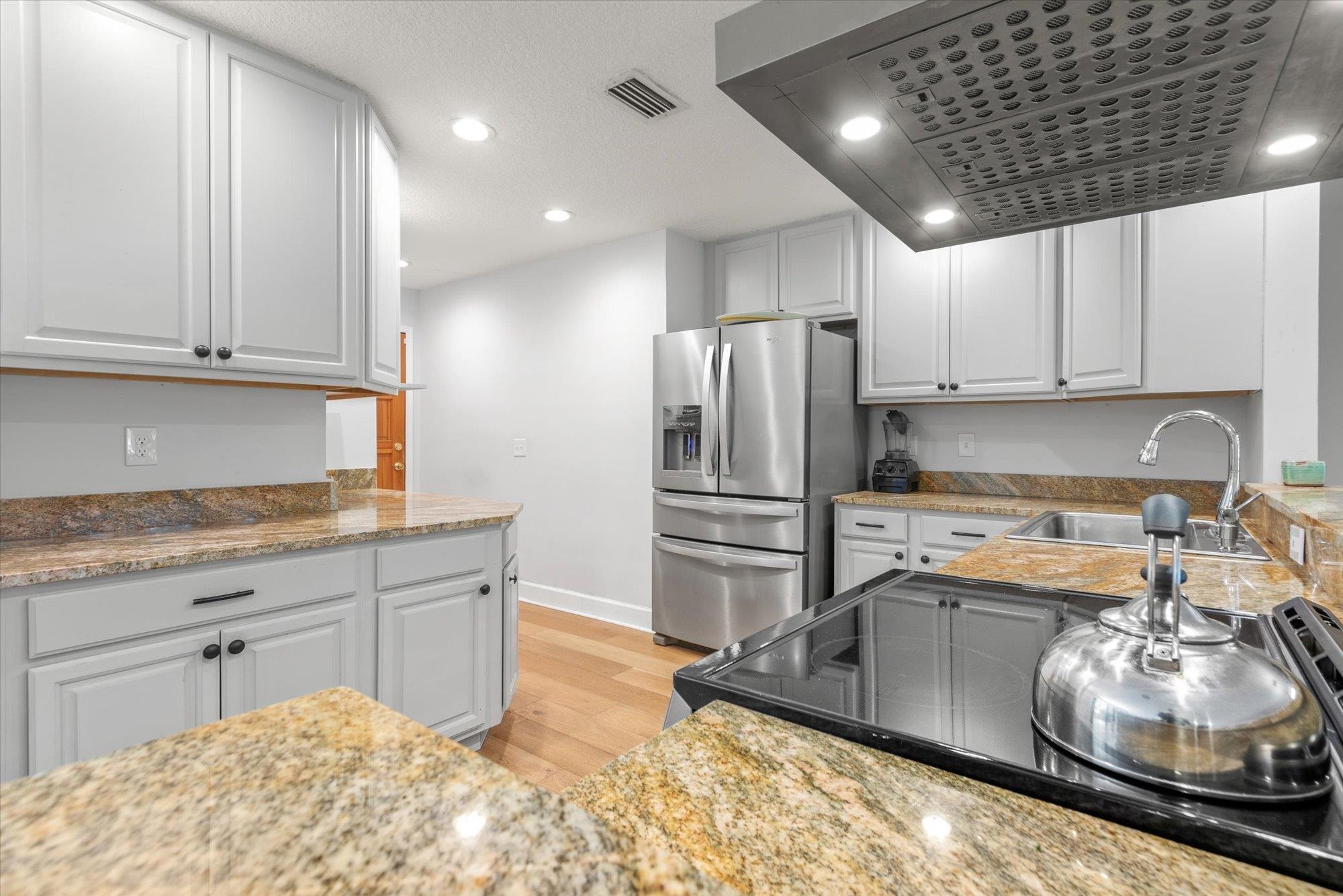 200 Raintree Trail St. Augustine, FL 32086 - Photo 12 of 36 a kitchen with stainless steel appliances granite countertop a sink refrigerator and cabinets